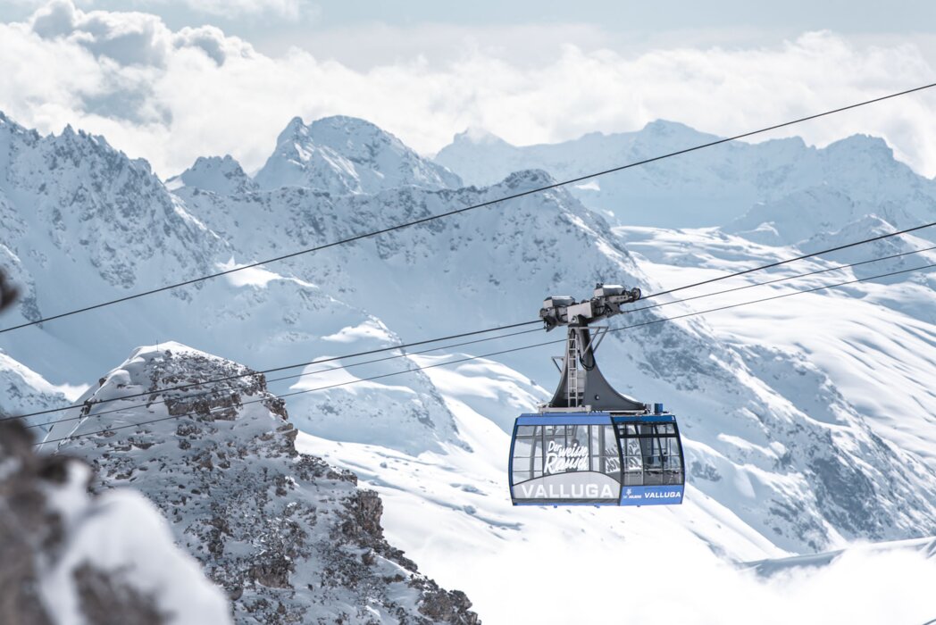 Seilbahn in der Skiregion St. Anton am Arlberg mit verschneiten Bergen im Hintergrund.
